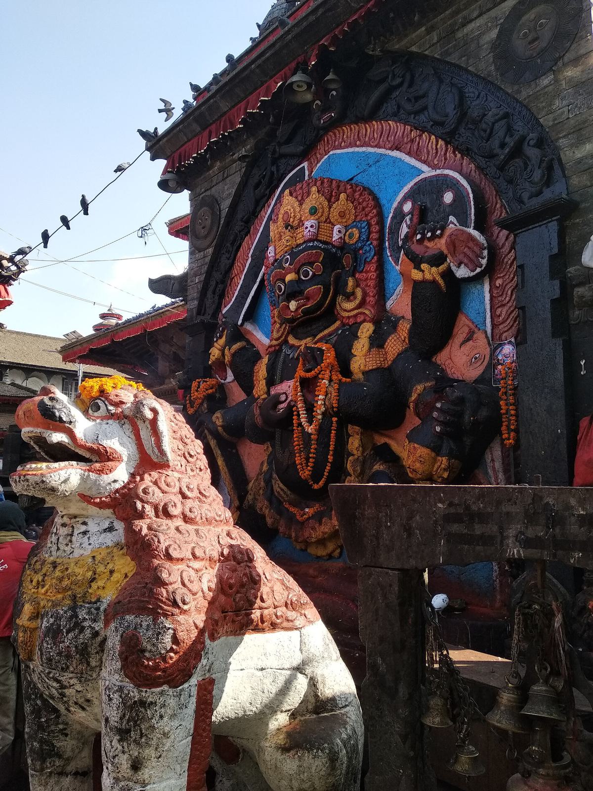 The Kaal Bhairav statue at Hanuman Dhoka, Kathmandu Durbar Square, with its lion guardian